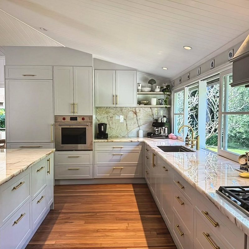 White shaker kitchen with timber floors and wall oven