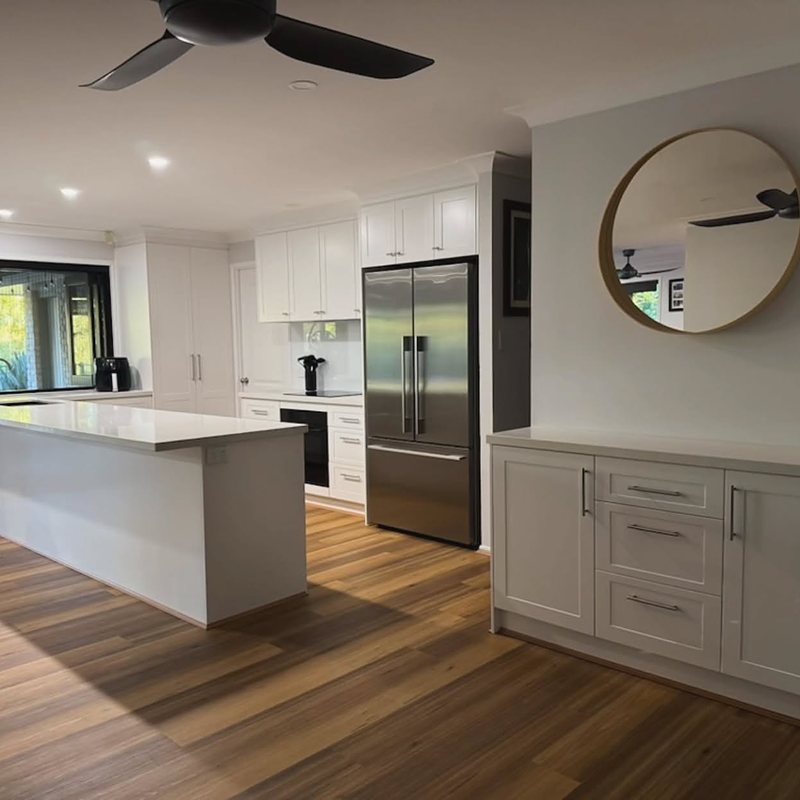 White shaker kitchen with integrated fridge cabinetry and island