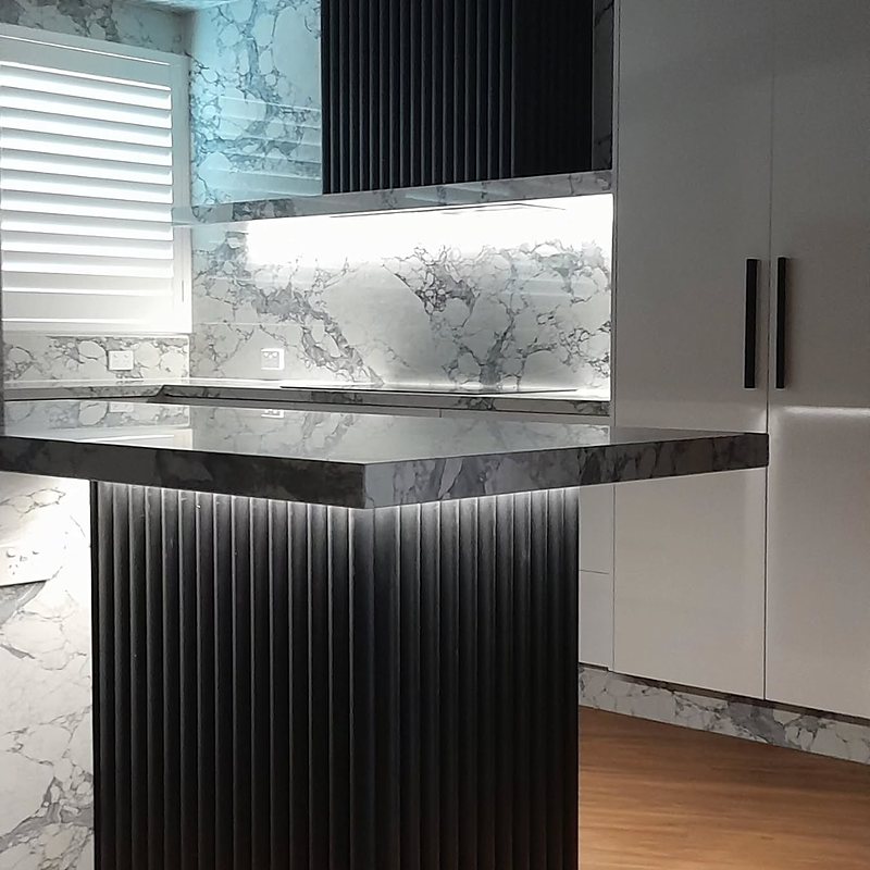 Marble splashback with black fluted feature panels